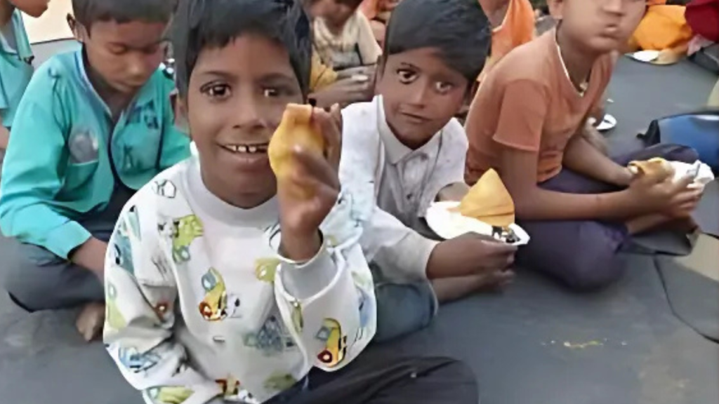 Underprivileged children eating meal provided by NGO