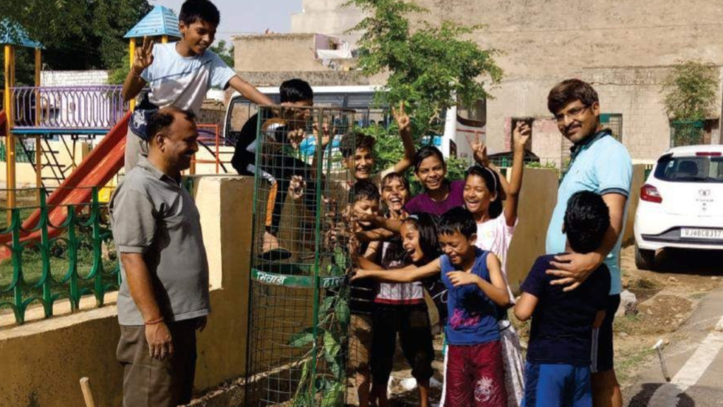 Founder of Oshi Foundation smiling and playing with children from underprivileged communities, creating joyful learning moments