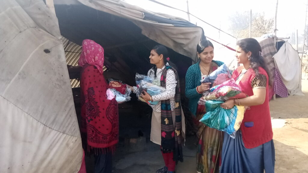 Poor mother and child receiving clothes from NGO volunteers
