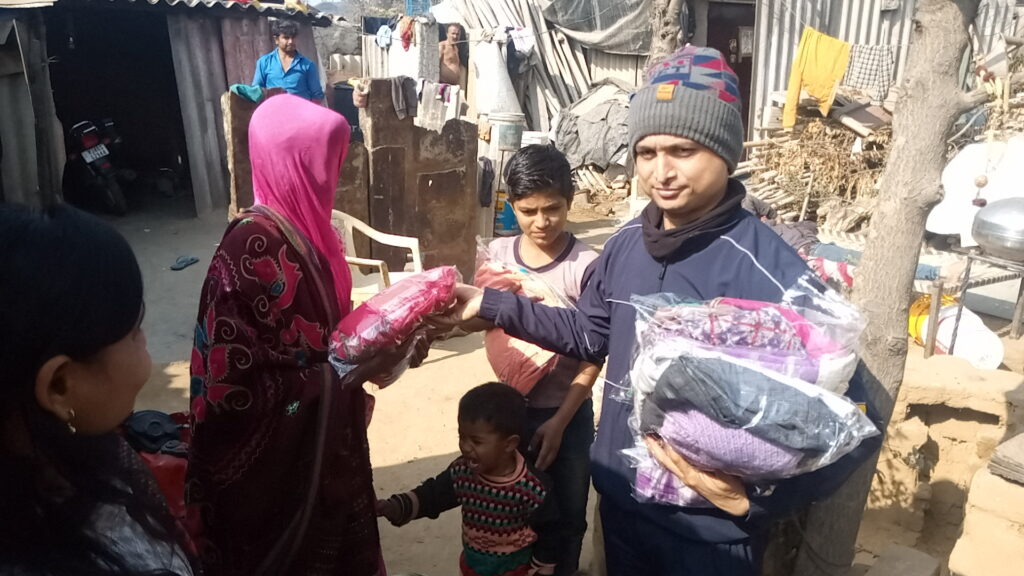 Poor mother and child receiving clothes from NGO volunteers
