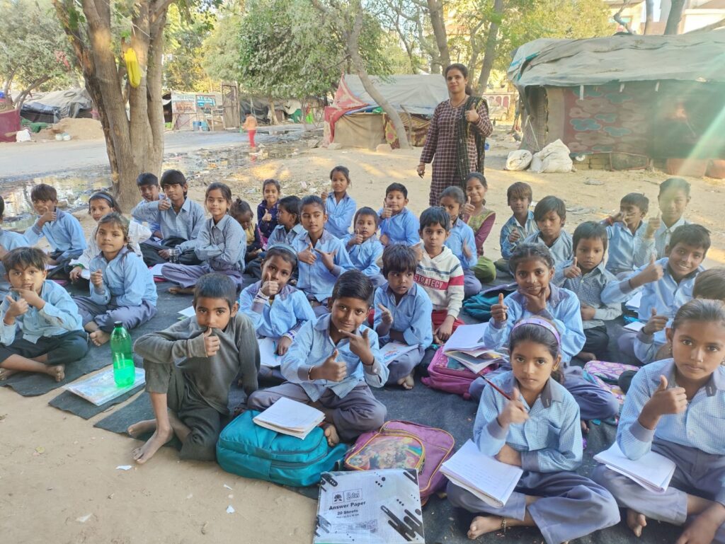 Volunteer teaching poor children at an NGO-run school in Rajasthan
